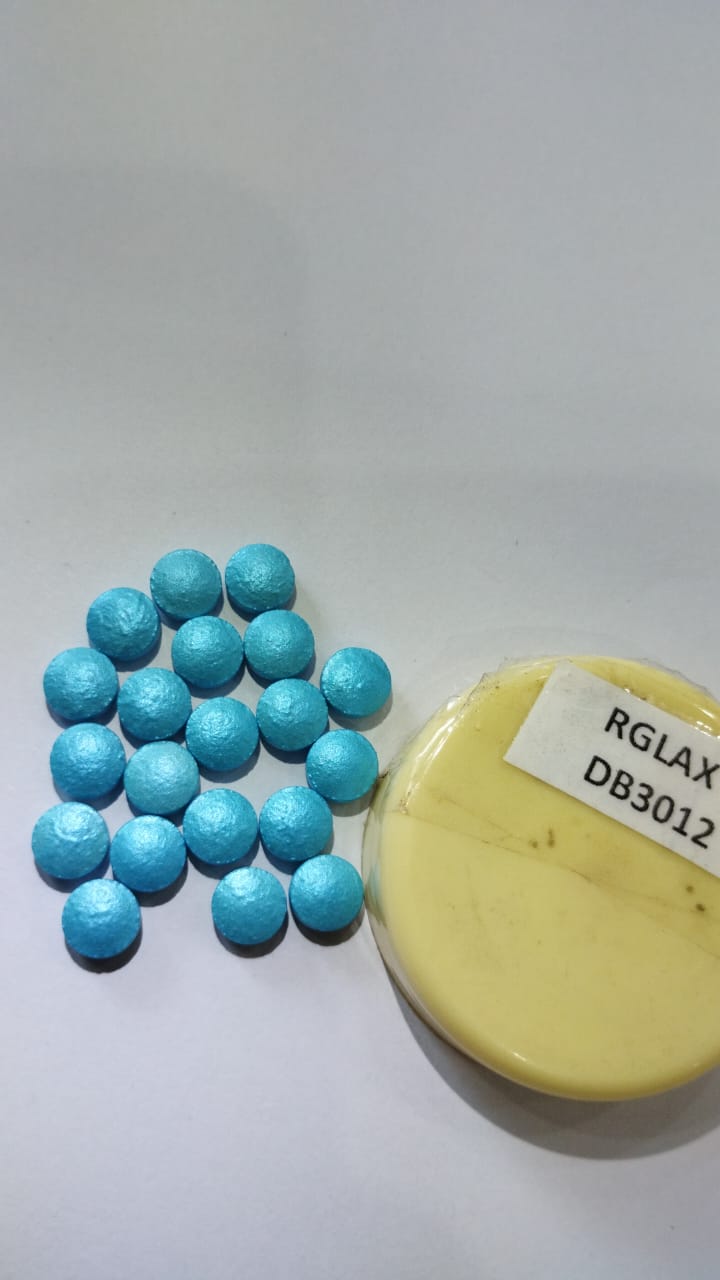 Metallic blue coated tablets beside an Rglax DB3012 coating dispersion